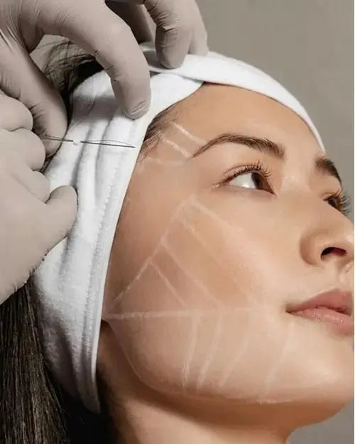 Person receiving a cosmetic procedure with a white towel on their head